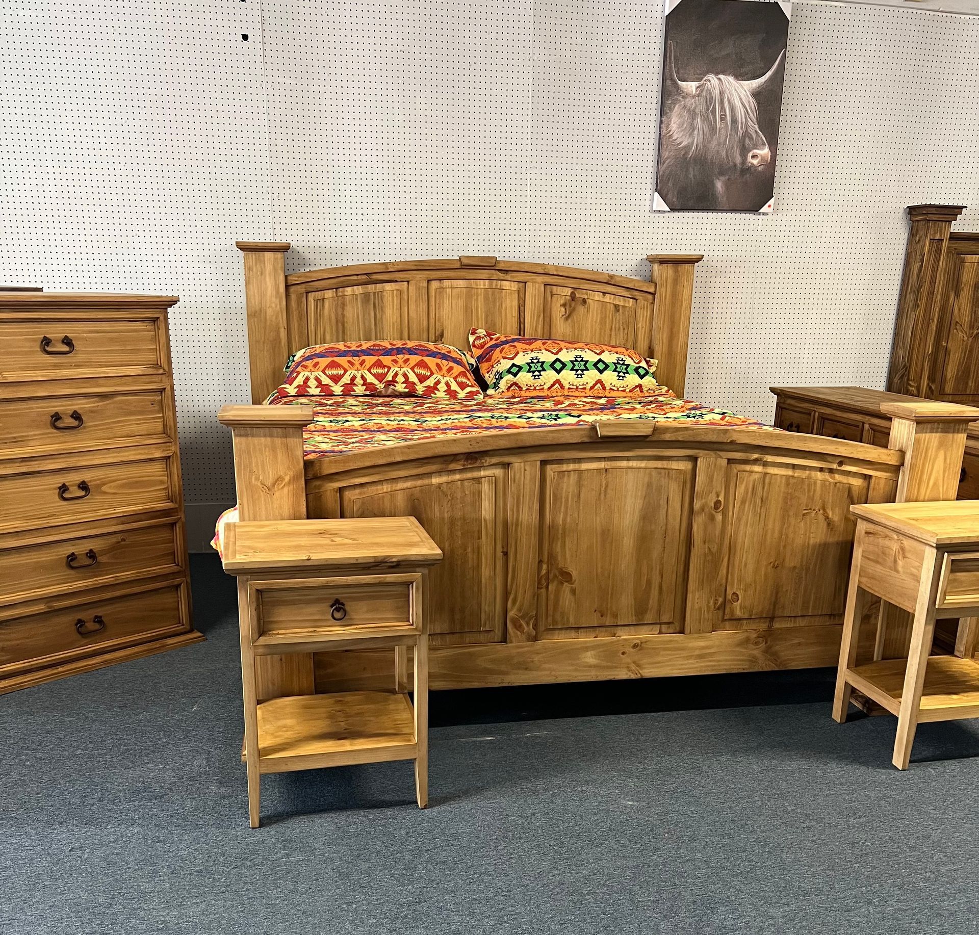Wooden bedroom set with a bed, dresser, nightstand, and two windows.