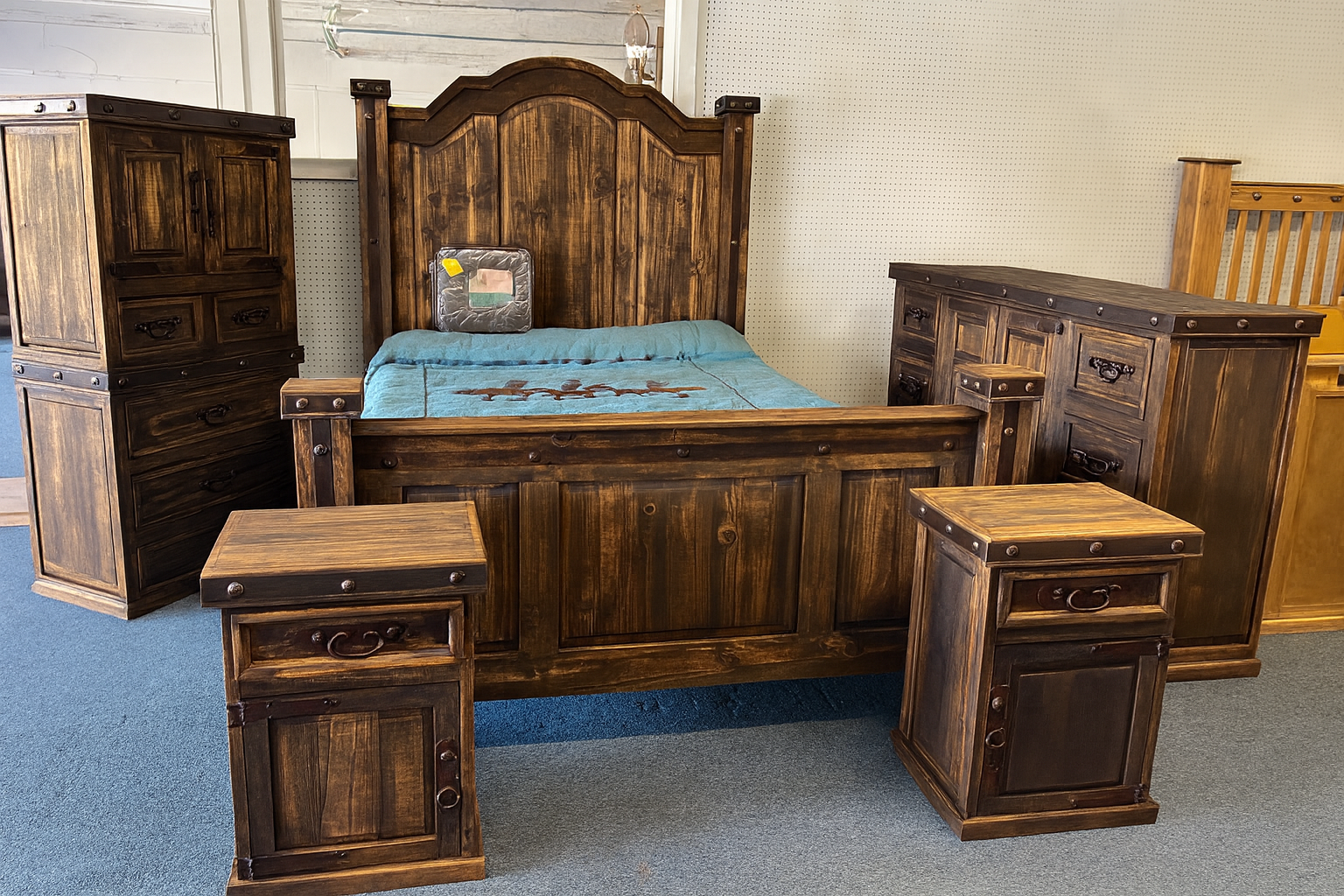 Rustic wooden bedroom set: bed, dresser with mirror, two nightstands, and tall chest.