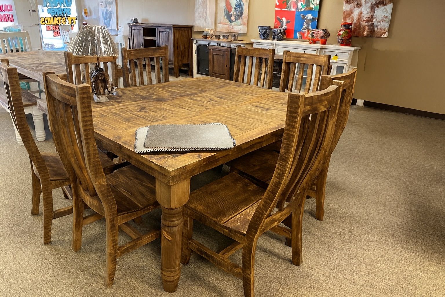 Wooden dining table set with six chairs in a furniture store.
