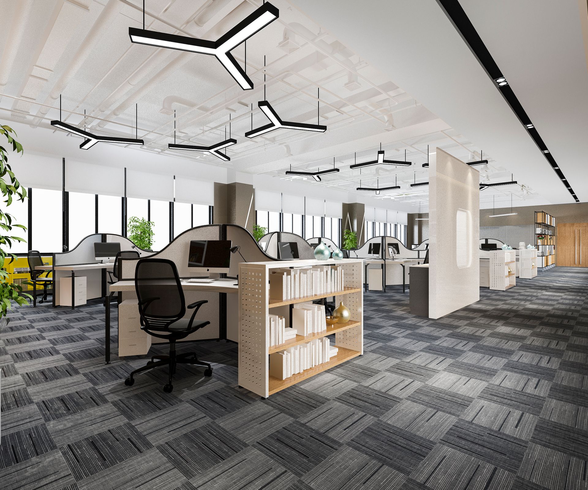 An office with a lot of desks and chairs and a bookshelf.