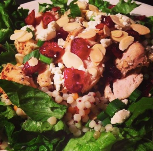 Salad with spinach, strawberries, almonds, cheese, and grilled chicken