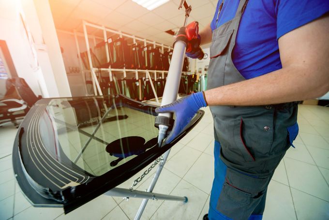 A Person Wearing Blue Gloves Is Working on A Windshield | Esk, QLD | ALSVET Windscreen Service