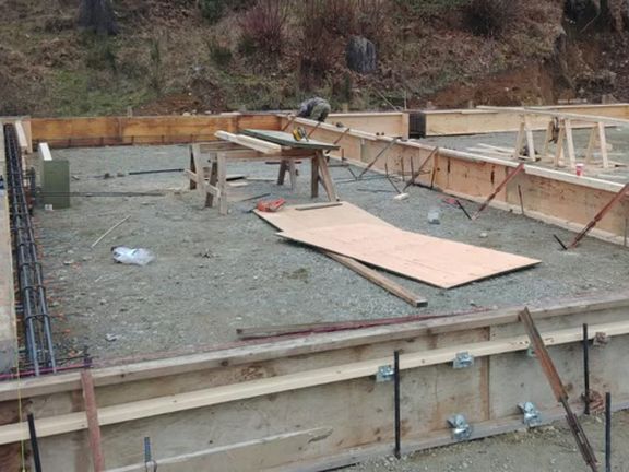 A construction site with a lot of wood and concrete.