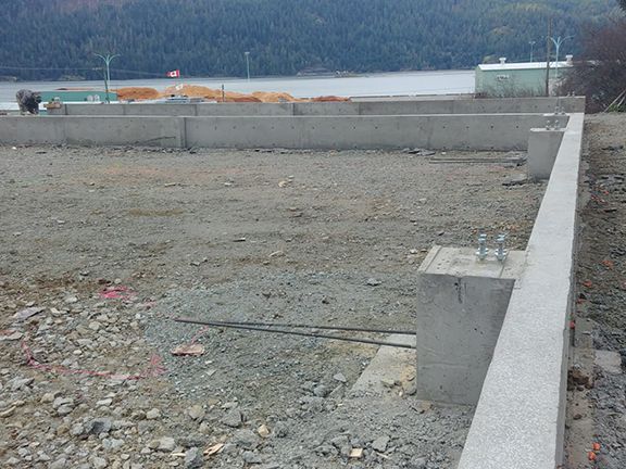 A construction site with a large body of water in the background