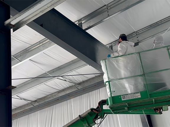 A man is standing on a lift in a building.