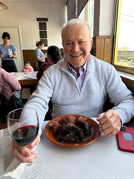 Benjamin enjoys a delicious order of octopus and Portuguese red wine in the Azores.