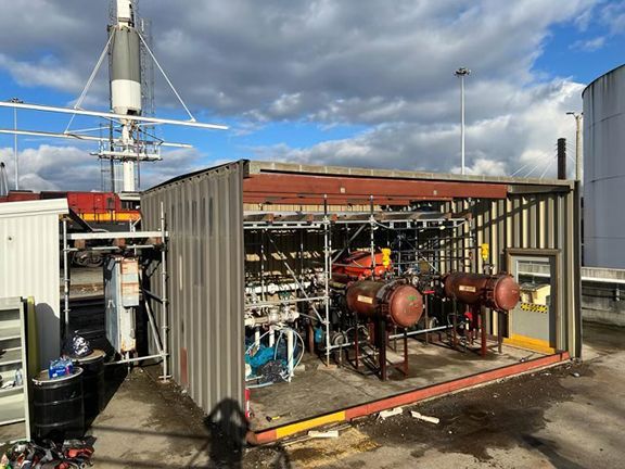 A large metal building with a lot of pipes inside of it.