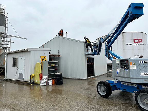 A group of men are working on the roof of a building.