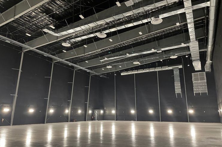 A large empty room with a lot of lights on the floor and ceiling.