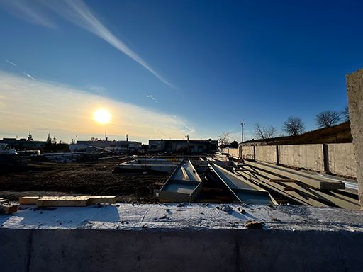 The sun is setting over a construction site