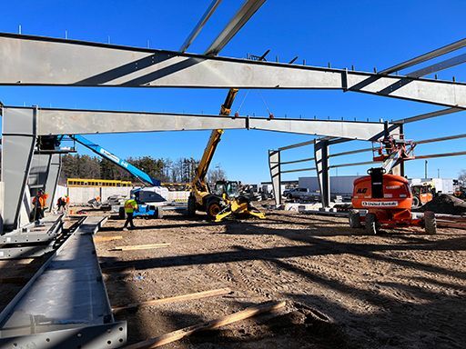 A construction site with a lot of machinery and workers.
