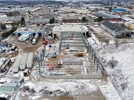An aerial view of a building under construction in the snow.
