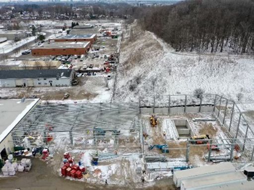 An aerial view of a building under construction in the snow.
