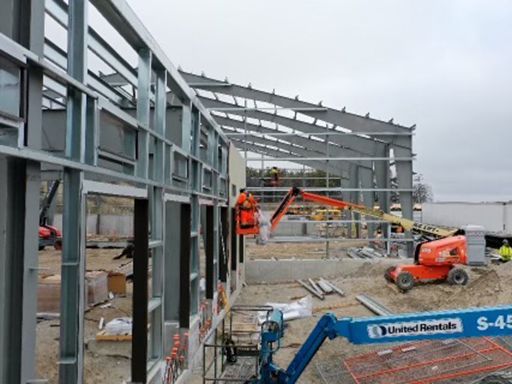 A large building is being built with a crane.