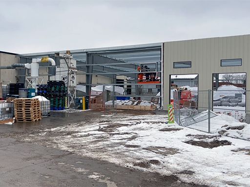 A large building is being built in the snow.