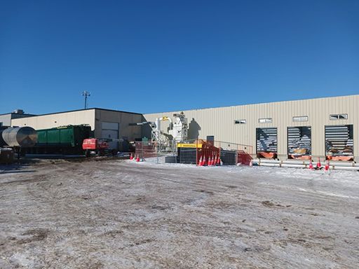 A large building with a lot of vehicles parked in front of it