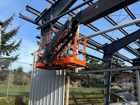 Metal wall siding being added to a commercial building construction project.