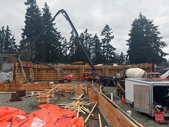 Crane lifts rebar into place at metal building project in British Columbia.