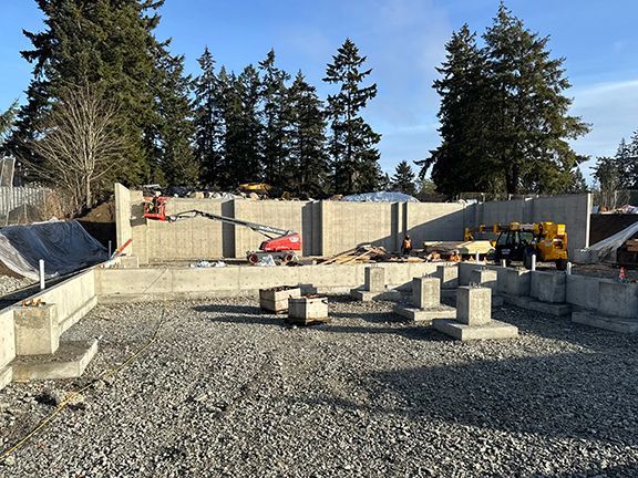 View of concrete foundation wall at Windsor Plywood building project on Salt Spring Island.