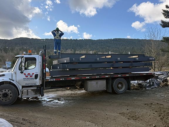 First delivery of structural steel beams for Windsor Plywood building project in British Columbia.