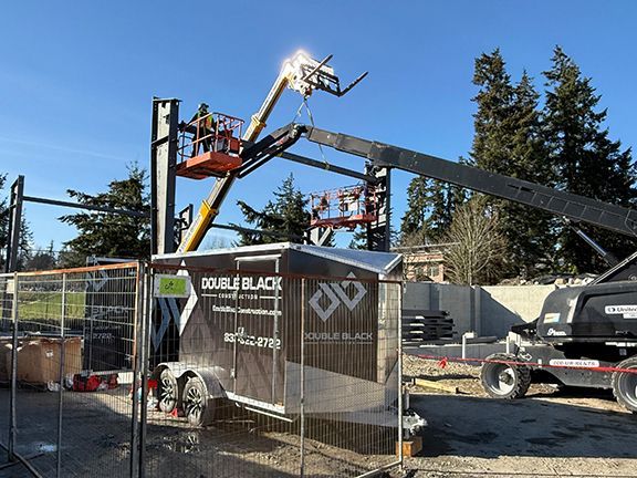 Team lifts roofing structural beams on Double Black Construction site on Salt Spring Island.