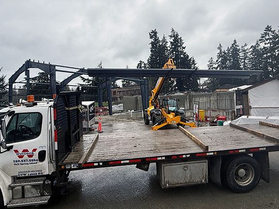 Last steel beams lifted off of transport truck in British Columbia jobsite.