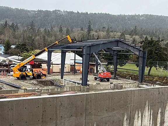End view of roofing beams being added to industrial metal building project in BC.