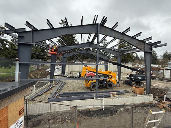 Steel framing for warehouse is made secure and strong atop concrete foundation in British Columbia.