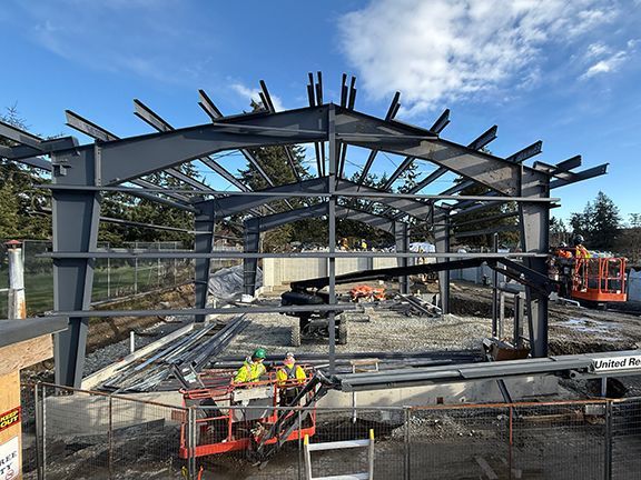 More steel framing is added to industrial building at construction site by Double Black Construction.