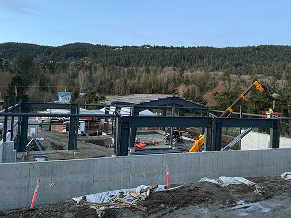 Steel structural framing can be seen at a commercial building construction site in British Columbia.