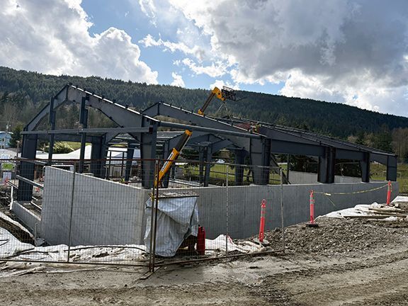 Side view of industrial steel building under construction in British Columbia.