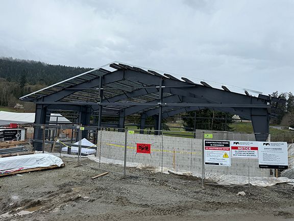Waterproofing being added to metal building construction site.