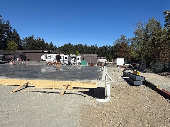 Nice view of wooden forms and concrete foundation pad at PEMB site in British Columbia.