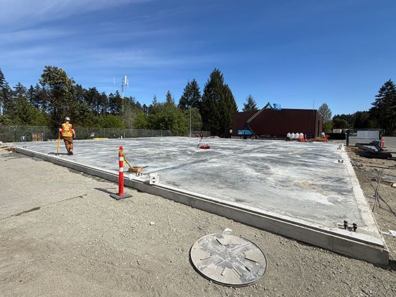 Completed concrete foundation pad for PEMB structure by Double Black Construction.