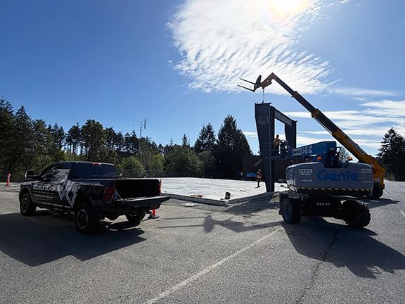 Sunny day as steel framing is added to building construction site.