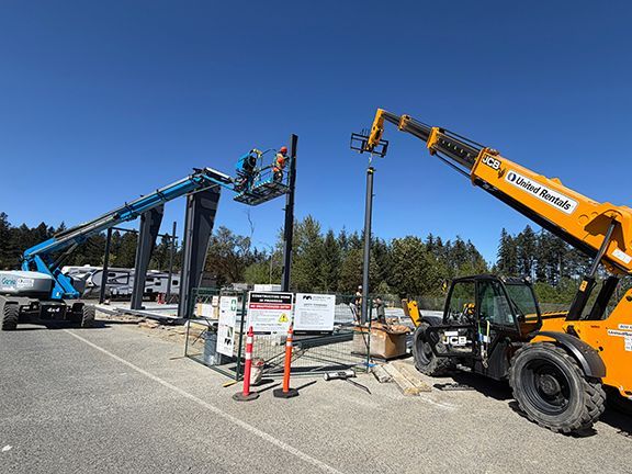 Construction crew uses crane to add more steel I-beams to PEMB project.