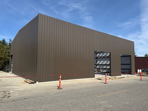 Brown metal wall panels completed at PEMB building project.