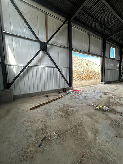 Interior look at metal building wall panels and supporting crossbeams
