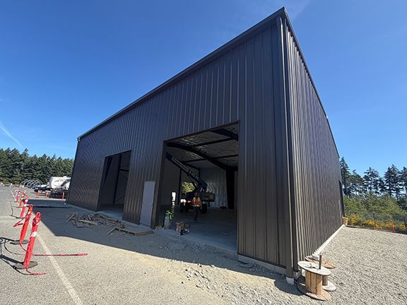 Construction worker adds finishing touch to PEMB project in BC