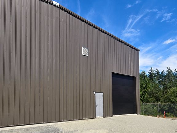 Doors are added to brown metal building to complete project for VMAC