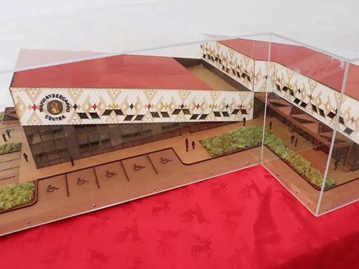 A model of a building in a clear case on a table