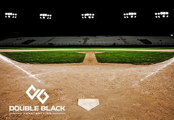 A baseball field with a double black logo on it
