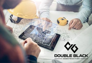 A group of construction workers are looking at a tablet with a 3d model of a building on it.