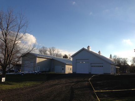 A white barn with a blue sky in the background