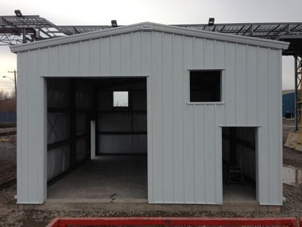 A white building with a door open and a window