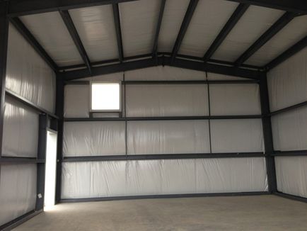 An empty metal building with a window in the ceiling