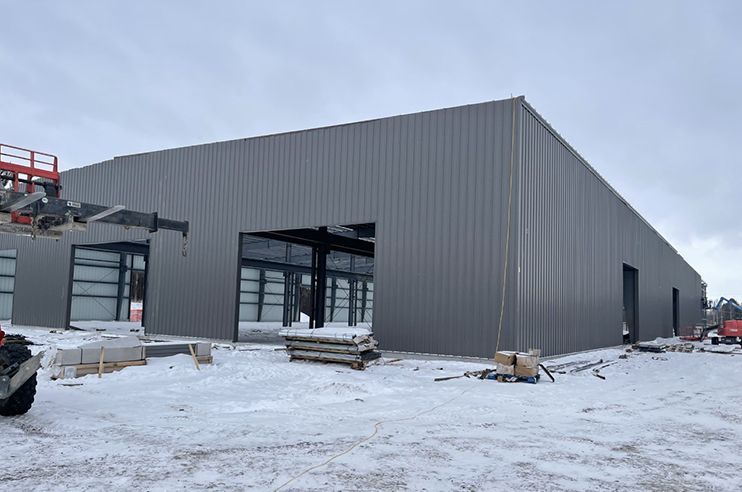 A large building is being built in the snow.