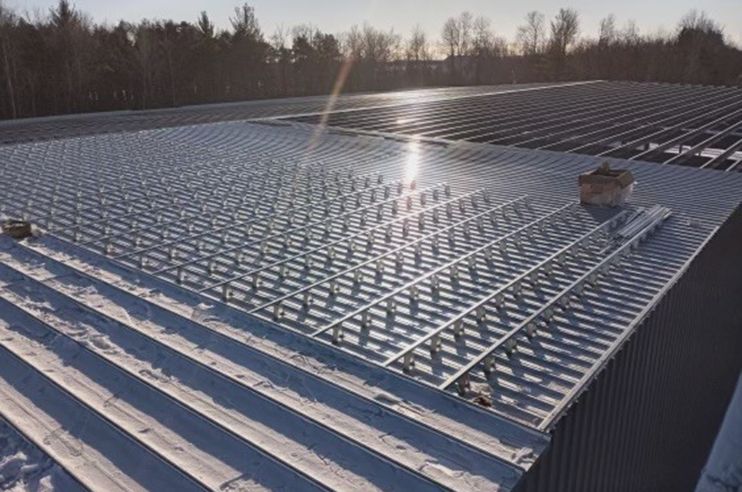 The sun is shining through the roof of a building