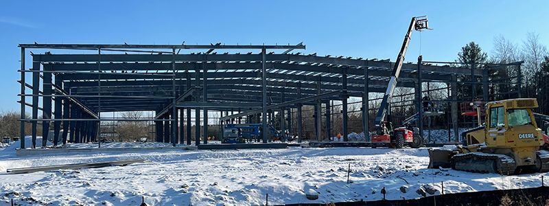 A large building is being built in the snow.