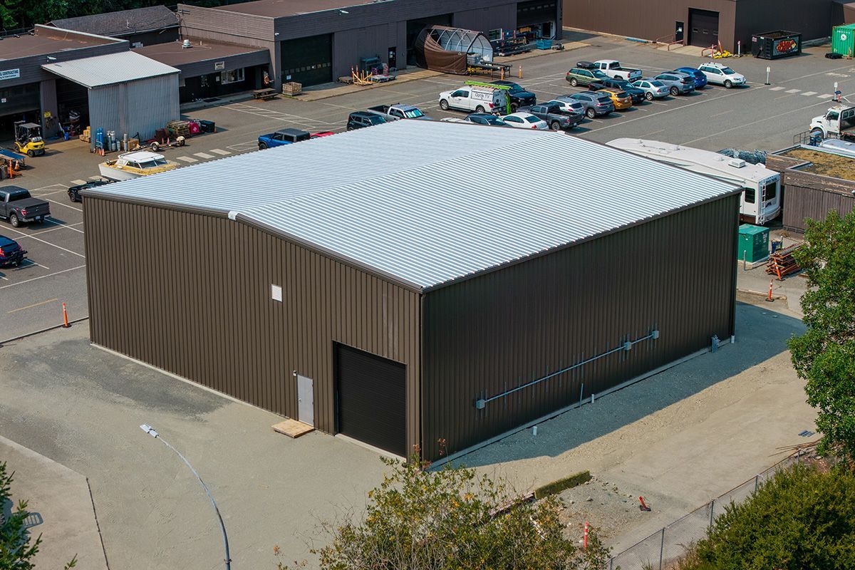 Aerial view of brown metal building erected on Vancouver Island